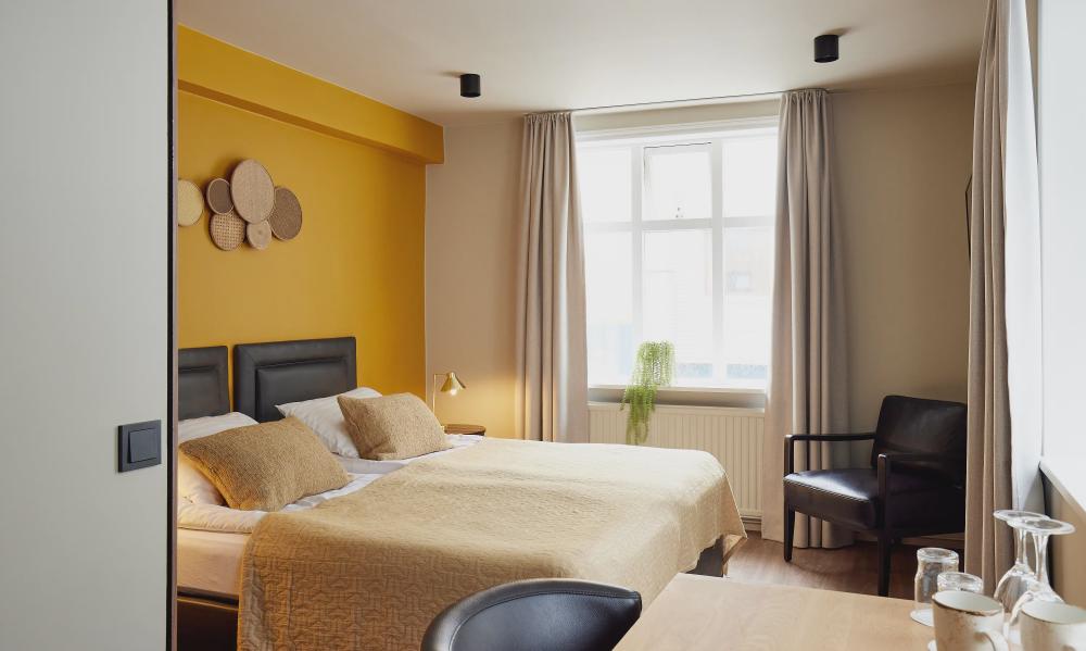 Modern bedroom with a yellow wall behind
